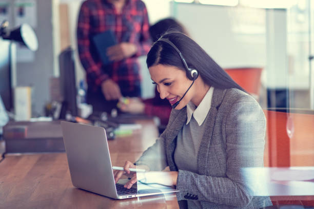 istock Beautiful call center agent browsing the internet on her computer 1188102666