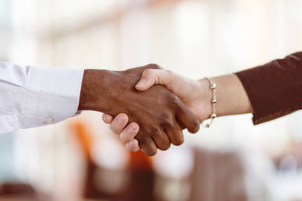istock Handshake between african and a caucasian man. 1188104446