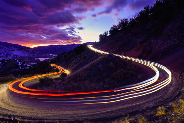 Time Exposure Driving Dirt Road Curve at Twilight stock photo