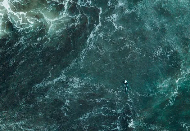 Photo of Abstract view of surfer in ocean.