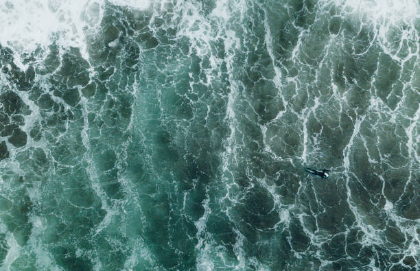 istock Abstract view of surfer in ocean. 1188109907