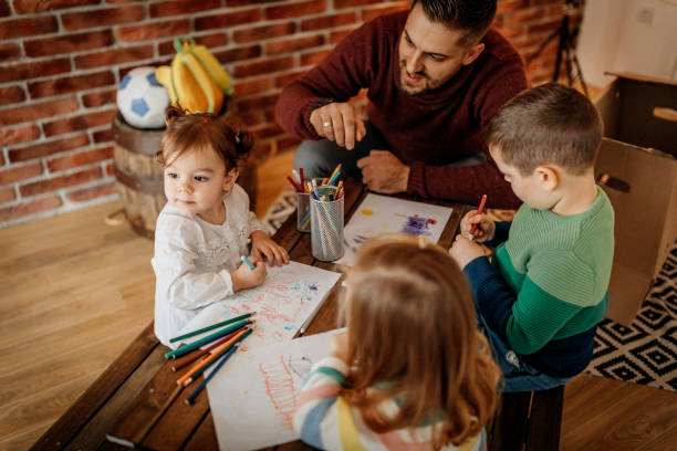 istock Father teaching kids to draw 1188113229