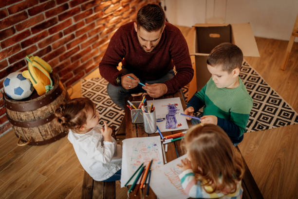 istock Father teaching kids to draw 1188115264