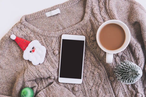 istock Empty screen smartphone with Cup of coffee and christmas ornament with copy space, Top view 1188116071