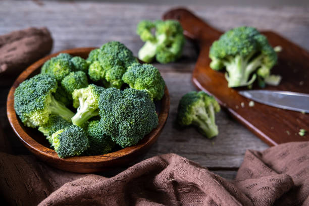 istock Fresh broccoli with wooden cutting board on old wooden table 1188116093