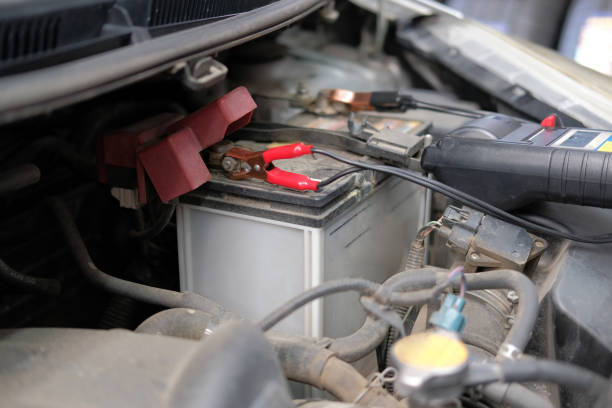 istock auto mechanic check car battery voltage by voltmeter multimeter 1188116907
