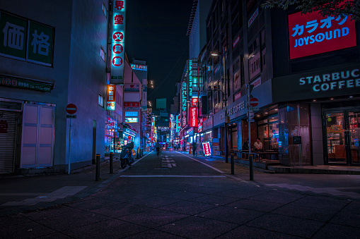 A night of the neon street at the downtown wide shot. Shinjuku district Tokyo / Japan - 08.29.2019 It is a famous town in Shinjuku. It's called SHIBUYA crossing. We can see many people & neon billboard.