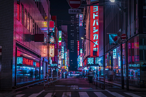 A night of the neon street at the downtown wide shot. Shinjuku district Tokyo / Japan - 08.29.2019 It is a famous town in Shinjuku. It's called SHIBUYA crossing. We can see many people & neon billboard.