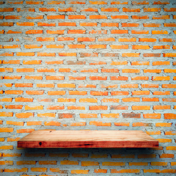 istock Empty wooden shelf on red brick background. 1188120346