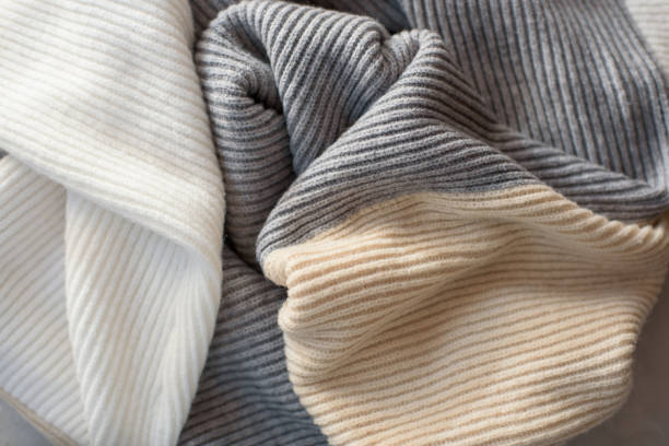 istock Warm knitted woolen takan pastel shades background. 1188135372