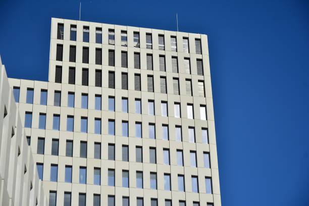 istock Modern office building detail. Perspective view of geometric angular concrete windows on the facade of a modernist brutalist style building. 1188146571
