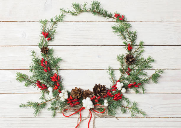 istock Christmas wreath on white wooden backdrop 1188148648