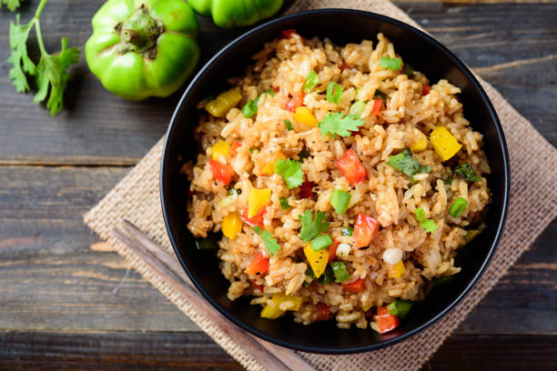 Fried rice with vegetables, Asian food Fried rice with vegetables in a bowl on wooden background, Asian food, top view fried rice stock pictures, royalty-free photos & images