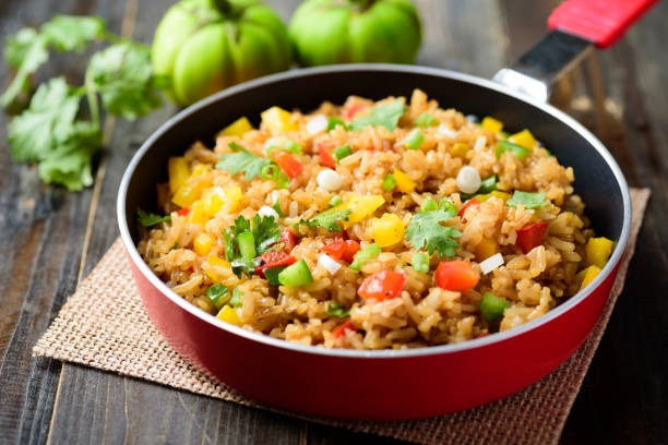Fried rice with vegetables, Asian food Fried rice with vegetables in cooking pan on wooden background, Asian food fried rice stock pictures, royalty-free photos & images