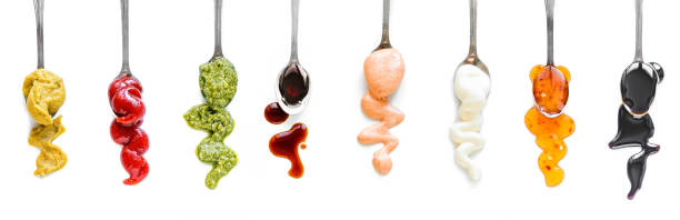 Sauces Assortment Sauces Assortment. Set of various sauces on spoons. Popular sauces isolated on white, top view, copy space. Homemade sauces set. dipping sauce stock pictures, royalty-free photos & images