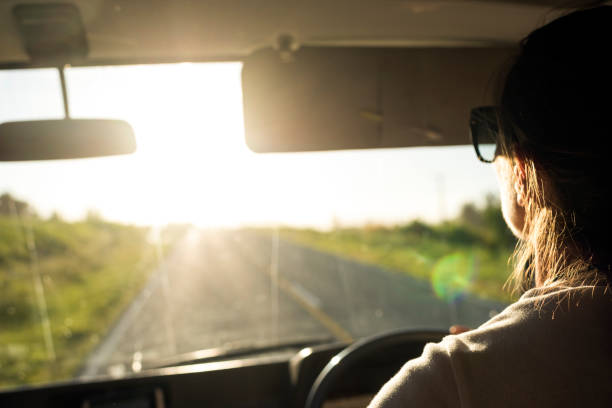 istock Woman driving a camper van towards the sun 1188151643