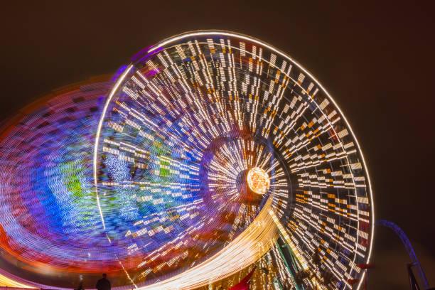 istock Two rides in motion in amusement park, night illumination. Long exposure. 1188153628