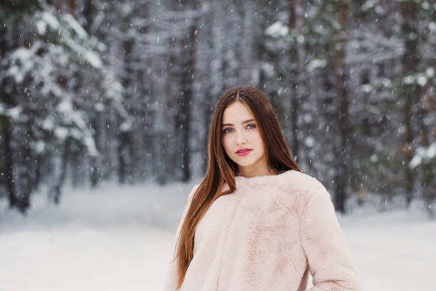 istock beautiful girl in winter forest 1188159168