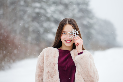 beautiful girl in winter snowy forest
