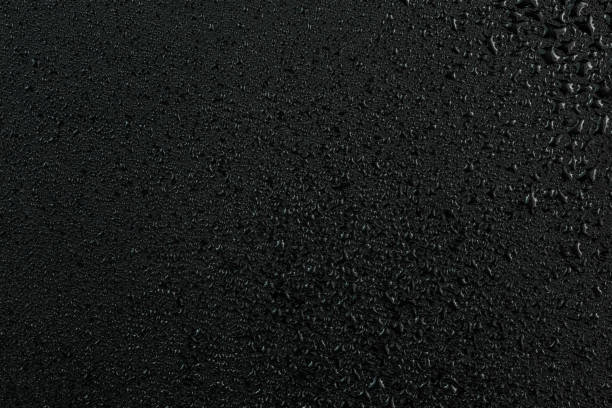 istock A dark abstract background of water drops on flat black rubber surface 1188161023