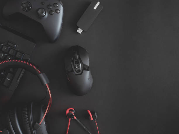 istock gamer work space concept, top view a gaming gear, mouse, keyboard, joystick, headset, mobile joystick, in ear headphone and mouse pad on black table background. 1188161343