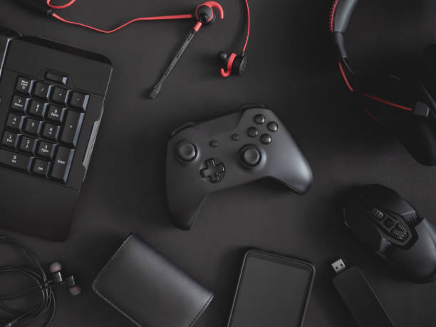 istock gamer work space concept, top view a gaming gear, mouse, keyboard, joystick, headset, mobile joystick, in ear headphone and mouse pad on black table background. 1188161345