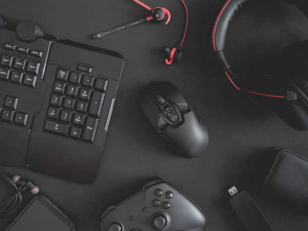 istock gamer work space concept, top view a gaming gear, mouse, keyboard, joystick, headset, mobile joystick, in ear headphone and mouse pad on black table background. 1188161352