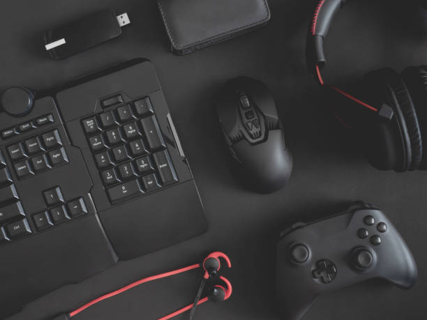istock gamer work space concept, top view a gaming gear, mouse, keyboard, joystick, headset, mobile joystick, in ear headphone and mouse pad on black table background. 1188161386