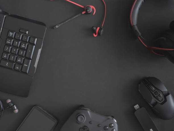 istock gamer work space concept, top view a gaming gear, mouse, keyboard, joystick, headset, mobile joystick, in ear headphone and mouse pad on black table background. 1188161403