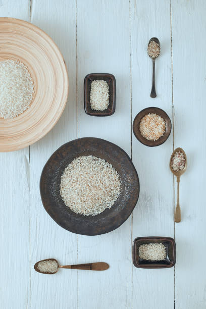 istock Rice of different varieties on wooden background. 1188161503