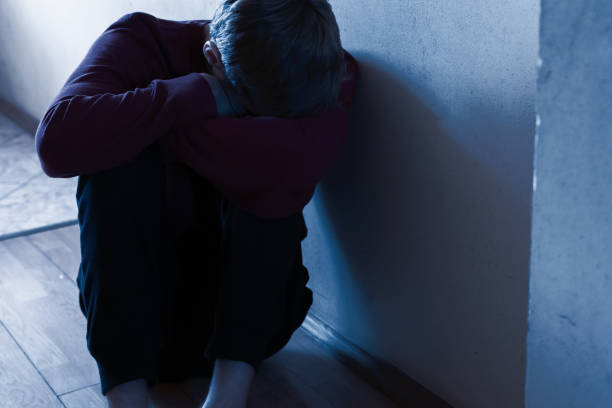 istock a depressed unhappy man sitting on the floor in the corridor 1188162283
