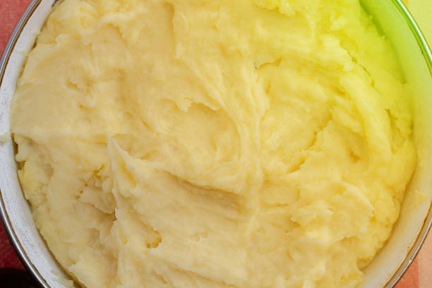 istock top view close up of mashed yellow potatoes texture with spoon in it 1188162296