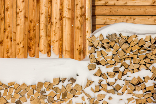 Wooden logs covered by snow