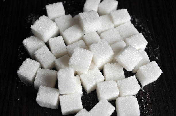 istock White and brown crystalline sugar. White and brown sugar in pieces 1188165589