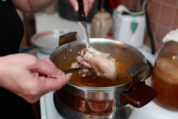 Cooking of russian meat aspic in kitchen