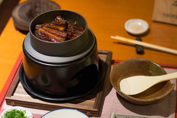 istock eel with rice in a small pot on a small stove in a restaurant 1188166177