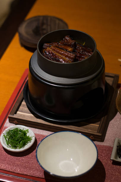 istock eel with rice in a small pot on a small stove in a restaurant 1188166876
