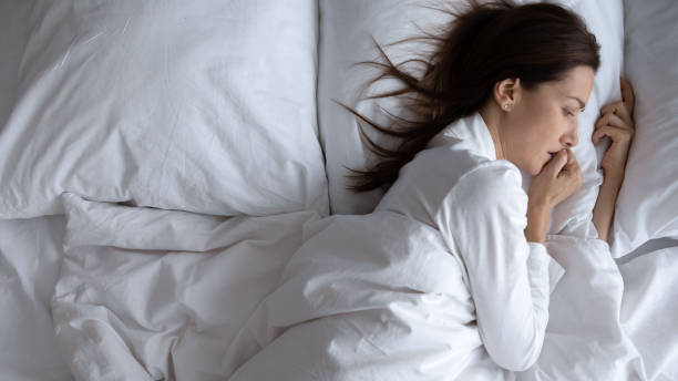istock Awoken lonely scared woman lying in bed alone, top view 1188167160