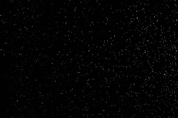 Realistic falling snowflakes. Isolated on black background.