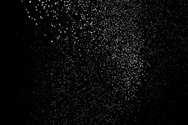 Realistic falling snowflakes. Isolated on black background.