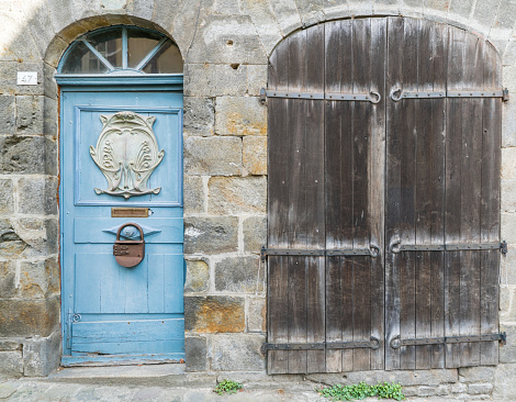A close up of a house front with blue and brown wooden door