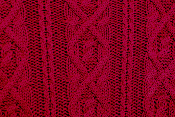 istock Knit texture of maroon wool knitted fabric with cable pattern as background. Magenta texture. 1188172291