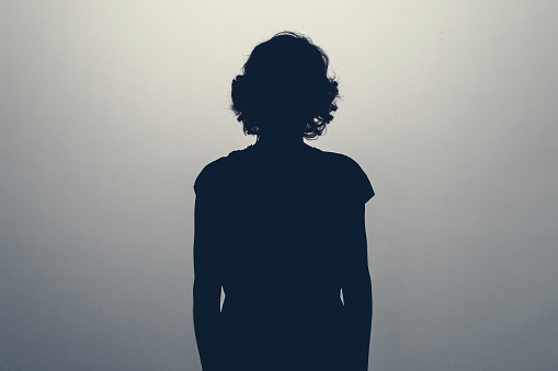 Unknown female person silhouette in studio. Concept of depression