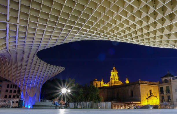 Sevilla, Spain - August 4, 2019: The structure of the Espace Metropol Parasol by architect Jurgen Mayer on Plaza de la Encarnacion at night. The artwork is designed by the architect Jürgen Mayer and completed in April 2011.