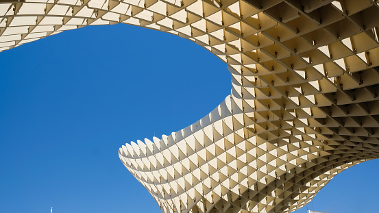 Sevilla, Spain - August 4, 2019: The detail of the sunshade structure of the Espace Metropol Parasol by architect Jurgen Mayer on Plaza de la Encarnacion. The artwork is designed by the architect Jürgen Mayer and completed in April 2011.
