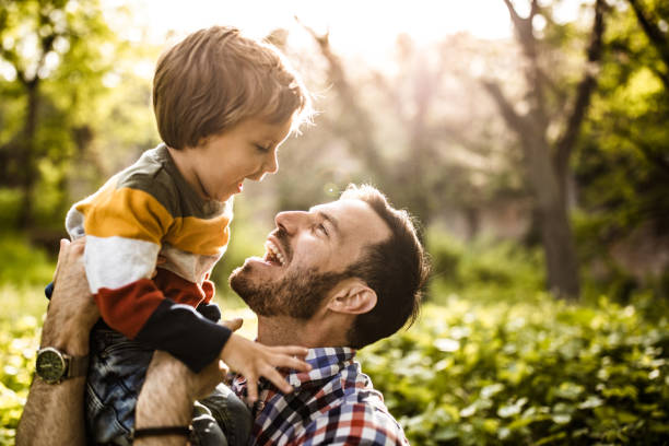 istock Happy single father and son having fun while talking in nature. 1188182008