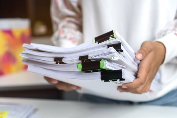 istock Asian Business female working holding many unfinished documents paperwork report files on overwork desk office, preparing to presenter for administrator, research documentation in education concept 1188189251