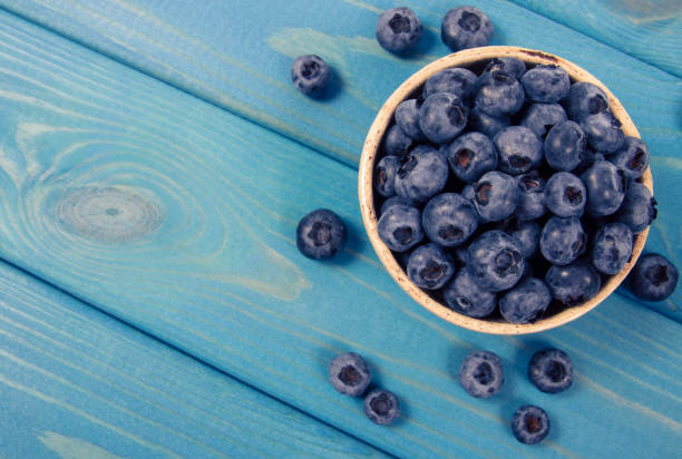 istock Raw fresh huckleberry in a bowl. Wooden background. 1188189414