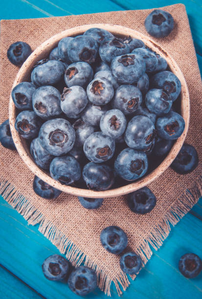 istock Raw fresh huckleberry in a bowl. Wooden background. 1188189472