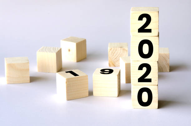 istock New year 2019 change to 2020 concept, wooden cube on white floor background. 1188189601